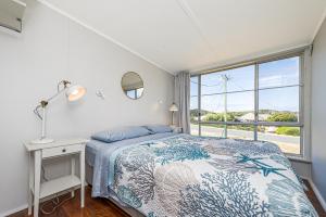 a bedroom with a bed and a window at Love You Moore in Guilderton