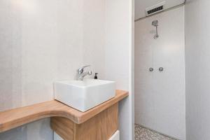 a bathroom with a white sink and a shower at Love You Moore in Guilderton +20 photos