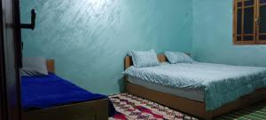 Postel nebo postele na pokoji v ubytování Gite Atlas Imzoughe