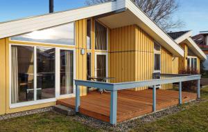 a house with a deck with a table on it at Amazing Home In Rechlin With Wifi in Rechlin