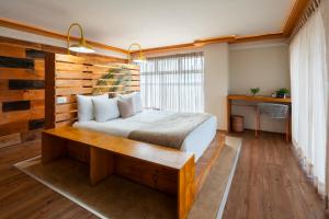 a bedroom with a bed and a wooden wall at Mayan Monkey Cancun - Social Hotel in Cancún