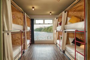 a room with two bunk beds and a window at Mayan Monkey Cancun - Social Hotel in Cancún