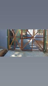 a gate in a building with a fence at Vila mar azul in Imbassai