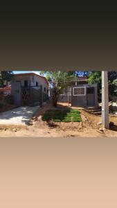two pictures of a house with a garage at Vila mar azul in Imbassai
