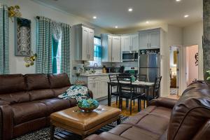 a living room with a couch and a kitchen at Top Floor with Skylight Brooklyn in Brooklyn