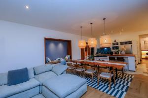 a living room with a blue couch and a table at Kokasemera Country Villa in Fort Portal