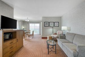 a living room with a couch and a dining room at SureStay Hotel by Best Western Camarillo in Camarillo