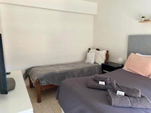 a room with two beds with towels on them at Sur Alojamiento Ushuaia in Ushuaia