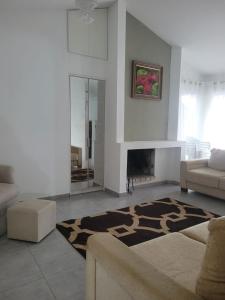 a living room with a couch and a fireplace at Casa espaçosa no coração de Floripa in Florianópolis