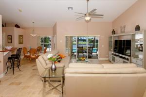 a living room with a white couch and a table at Alecia in Cape Coral