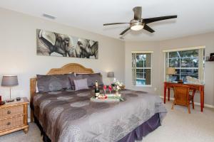 a bedroom with a bed and a ceiling fan at Alecia in Cape Coral +19 photos