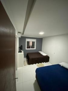 a bedroom with a blue bed in a room at Pé na Guarita in Torres