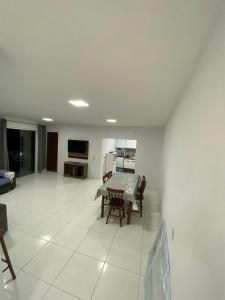 a kitchen and dining room with a table and chairs at Pé na Guarita in Torres