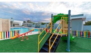a pool with a playground with a slide at Caribbean Breeze in Punta Cana