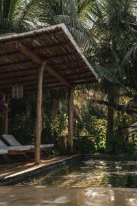 a wooden pergola next to a swimming pool at Casa Chula Hotel Boutique Frente al Mar in Tierra Blanca +263 photos