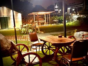 a wooden table and chairs and a table and a table and chairs at BlackJazz Inn in Puli +70 photos