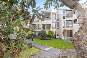 an apartment building with a garden in front of it at The Landing at Kailua Bay in Kailua-Kona