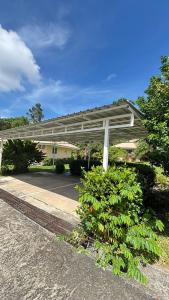 a white pergola in front of a building at Villa Sun 4 in Mae Nam