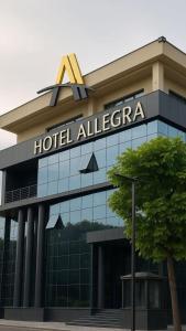 a hotel alteccca building with a sign on it at Hotel Allegra in Pristina