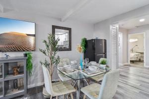 a dining room with a glass table and chairs at Entire Private Home with 2 Bedrooms 1 Bathroom, Gated Yard, Driveway Parking, Available Now in Spring Valley +44 photos