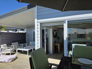 a patio with a sliding glass door with a table and chairs at Time Out in Pohara in Pohara