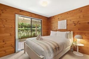 Ένα ή περισσότερα κρεβάτια σε δωμάτιο στο Cottage on Boambee