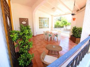 a balcony with a table and chairs on a patio at Spacious villa with a large veranda and pool in Floridia