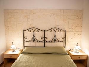a bedroom with a bed with two nightstands and two lamps at Spacious villa with a large veranda and pool in Floridia +32 photos