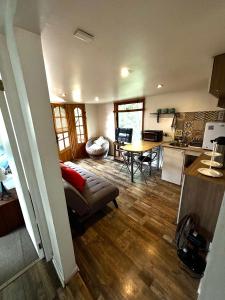 a kitchen and living room with a couch and a table at Cabaña en el bosque, Valdivia in Valdivia +7 photos