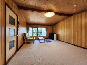 Ένα ή περισσότερα κρεβάτια σε δωμάτιο στο 民宿やいち