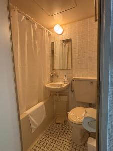 a bathroom with a sink and a toilet and a tub and a sink at P-Stay広島富士見町302 in Hiroshima