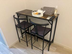 a small table with two chairs and a basket on it at P-Stay広島富士見町302 in Hiroshima +6 photos