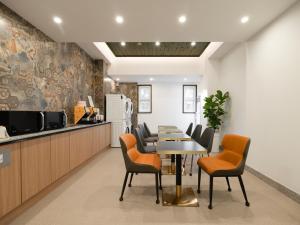a kitchen and dining room with a table and chairs at URBAN BROWN HOTEL Cheongju in Cheongju