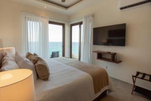 a bedroom with a large bed and a large window at Torre Marsai By MrW in Higuera Blanca