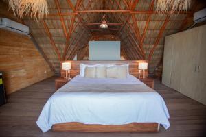 a bedroom with a large bed with two lamps at Torre Marsai By MrW in Higuera Blanca +157 photos