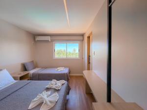 a small room with two beds and a window at Apto Luxo Gran Lençóis Atins 503 in Barreirinhas +52 photos