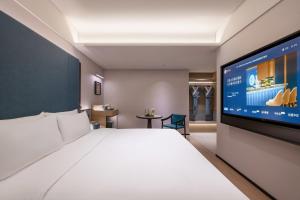TV a/nebo společenská místnost v ubytování Shenyang Olympic Sports Center Manxin Hotel + 15 fotografií