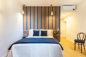 a bedroom with a large bed and a chair at MALACUCINA Casa Vacanze in Anagni