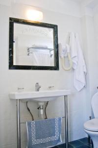 a bathroom with a sink and a mirror at Alonia Studios & Maisonettes in Tolo