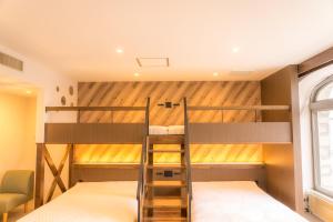 a bunk bed with a ladder in a room at BUB RESORT Yatsugatake in Hokuto