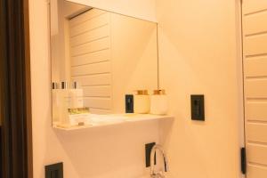 a bathroom with a mirror and a sink at BUB RESORT Yatsugatake in Hokuto +50 photos