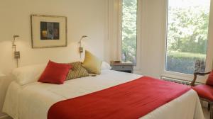 Postel nebo postele na pokoji v ubytování Quimera Lodge + 8 fotografií