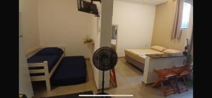 a room with a bedroom with a bed and a fan at Loft Centro in Aparecida