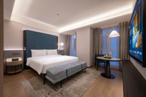 Postel nebo postele na pokoji v ubytování Shenyang Olympic Sports Center Manxin Hotel