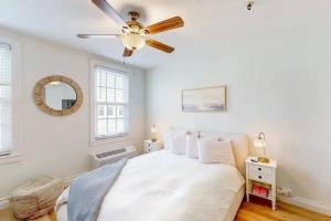 a bedroom with a bed with a ceiling fan at Palm Beach Condo 5 Mins to Beach Heated Pool in Palm Beach +15 photos