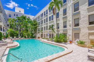a swimming pool in the courtyard of a apartment building at Palm Beach Condo 5 Mins to Beach Heated Pool in Palm Beach