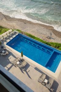 an overhead view of a swimming pool and the ocean at Torre Marsai By MrW in Higuera Blanca