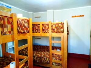 two sets of bunk beds in a room at Andes Hostel in Huaraz