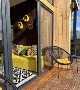 a patio with a couch and a chair on a deck at Feeling Freedom in Tukhlya +12 photos