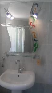 a bathroom with a sink and a mirror at Elisabeth Villas in Kerveli